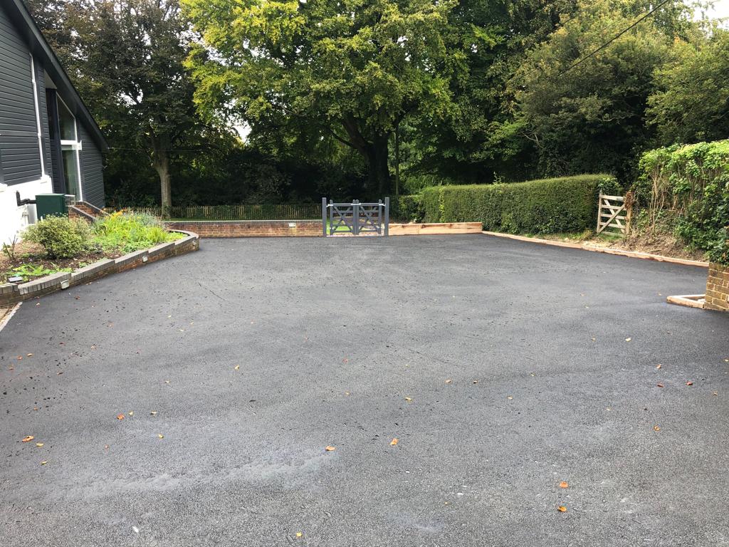 This is a photo of a bitumen driveway which is in the process of being installed by Booval Surfacing Solutions